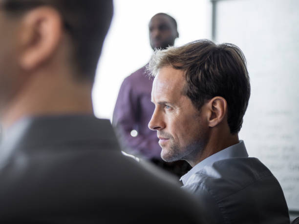 istock Serious businessman with colleagues in board room 1126622612
