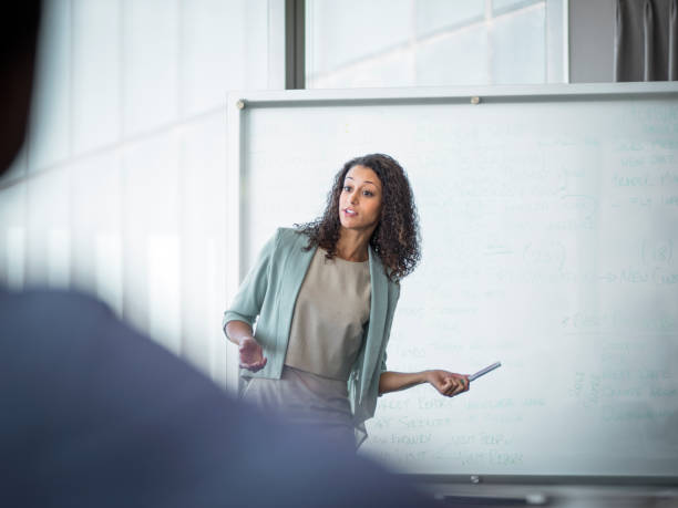 istock Businesswoman giving presentation on whiteboard 1126622632