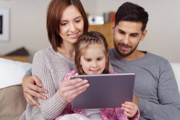 istock Young family looking at something on a tablet 1126622936
