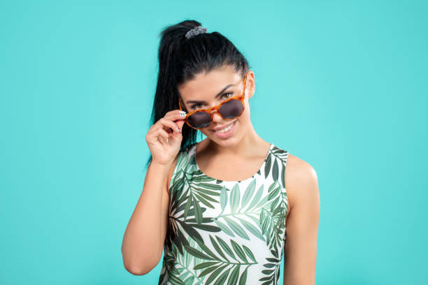 istock beautiful happy woman looking through the sunglasses 1126623521
