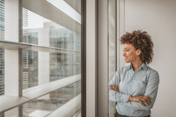 istock Mixed Race Businesswoman Looking out Window 1126625301