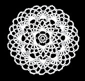 Isolated crocheted laced white doily with many picos at the egde on a black background. Round decorative cotton doily