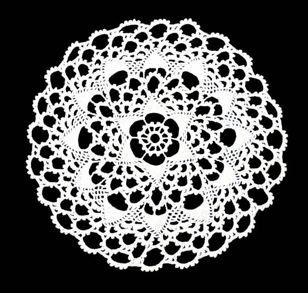 isolated crocheted laced white doily with many picos at the egde on a black background. round decorative cotton doily - naperão imagens e fotografias de stock