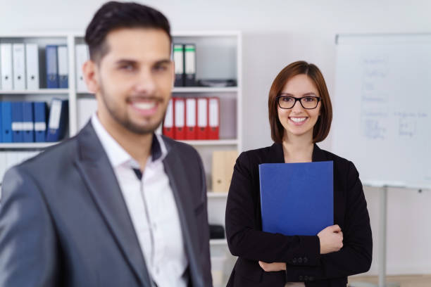 istock Business woman behind man at office 1126629510