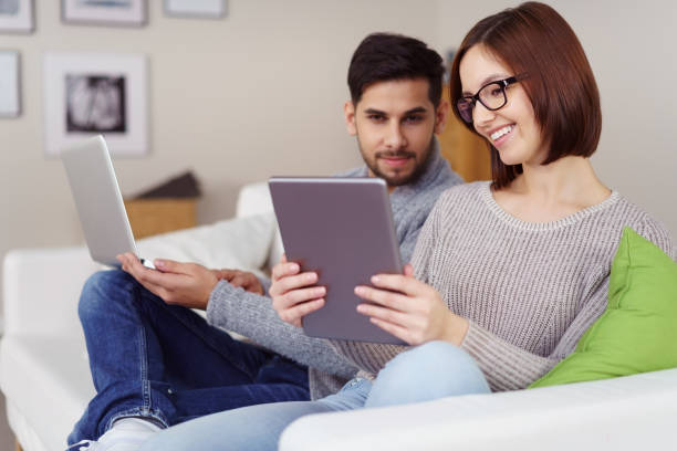 istock Smiling woman showing her husband something 1126630697