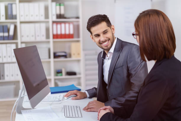 istock Business man smiling and talking with co-worker 1126630798