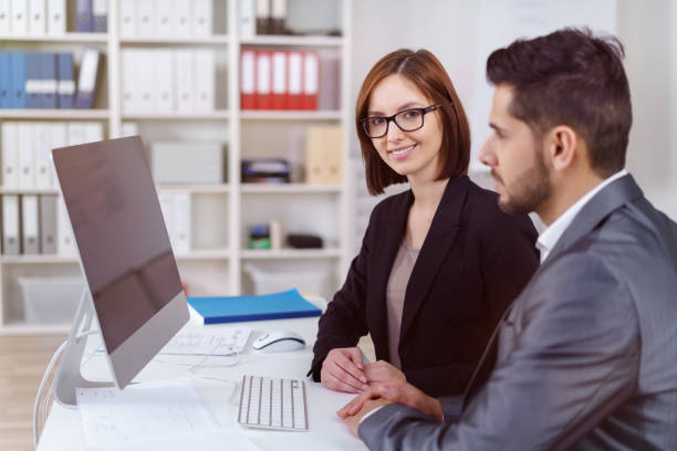 istock Business woman smiling and working with partner 1126630850