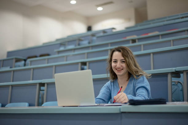 istock Woman working on laptop in a classroom 1126632964