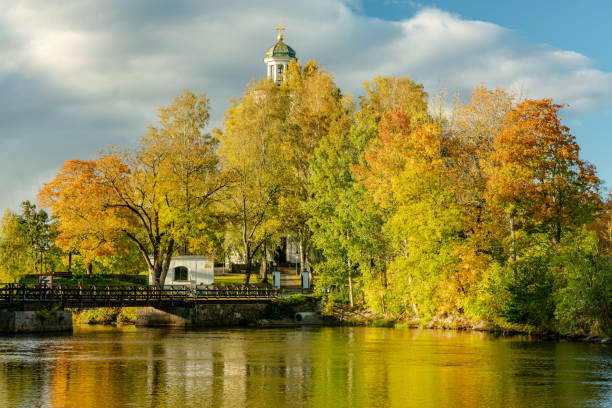 istock Beautiful autumn view across a river with colorful trees in bright sunlight 1126633212