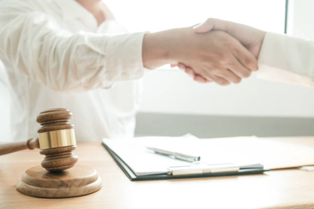 istock Lawyer handshake with client. Business partnership meeting successful concept. 1126634487