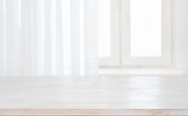 istock Wood table top on defocused pastel background of curtained window 1126634864