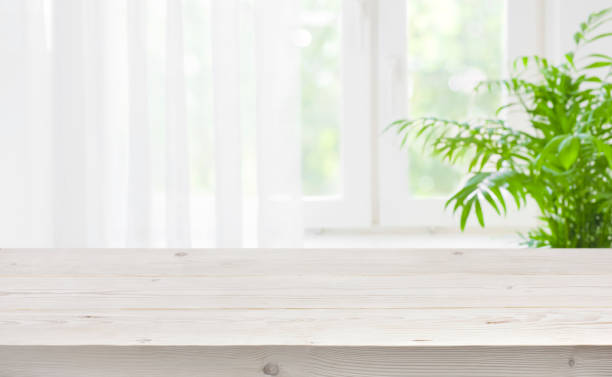 istock Wood table top on blurred background of window with curtain 1126635017