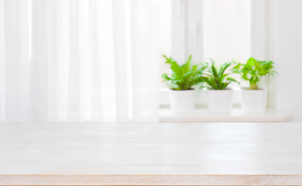 istock Empty top of wooden table on blurred curtained window background 1126635684