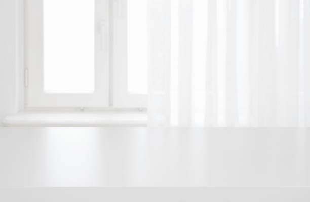 istock White table top on blurred pastel background of curtained window 1126635937