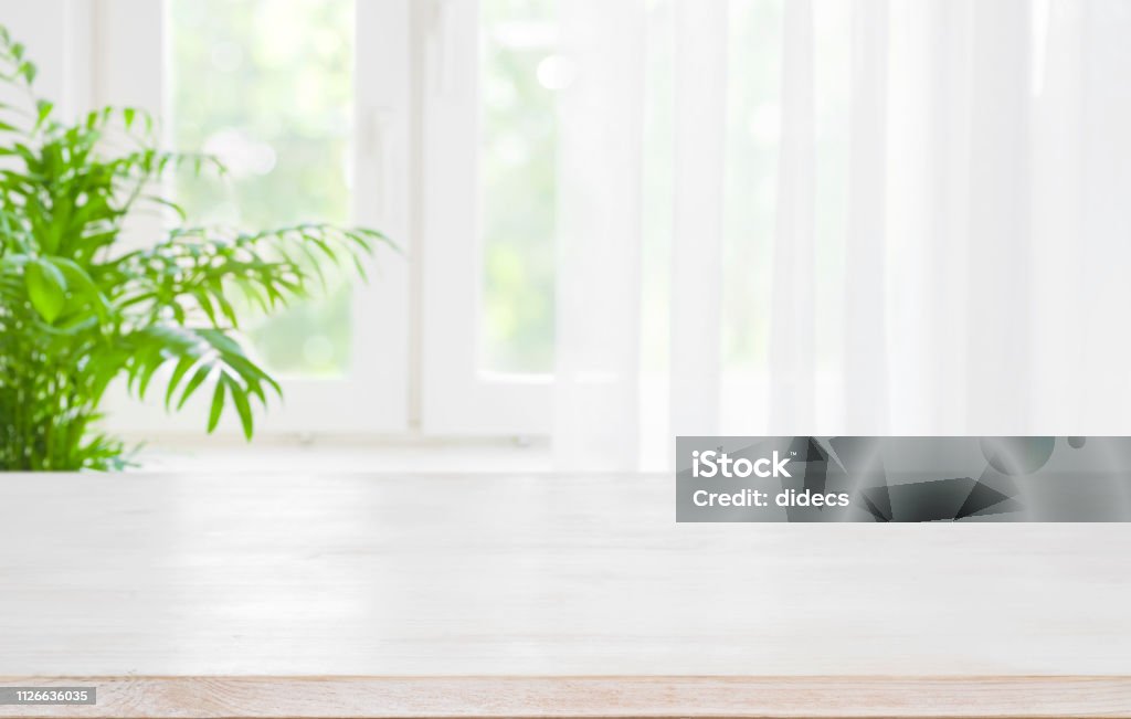 Wooden Table Top On Blurred Background Of Half Curtained Window Stock Photo  - Download Image Now - iStock