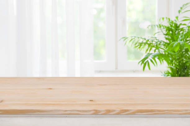 istock Top of brown wood table on blurred curtained window background 1126636038