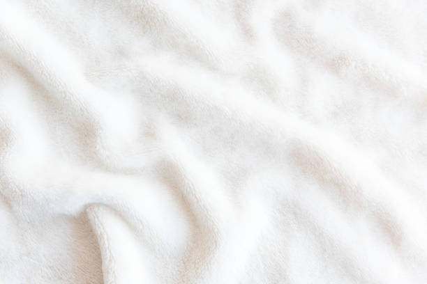 white delicate soft  background of plush fabric. texture of beige soft fleecy blanket textile with twisted folds. - soft imagens e fotografias de stock