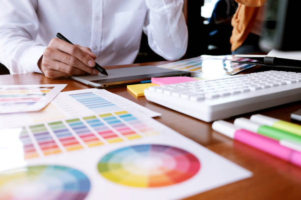 istock Graphic designer working on digital tablet. artist drawing on graphic tablet and Color swatch samples. 1126639821