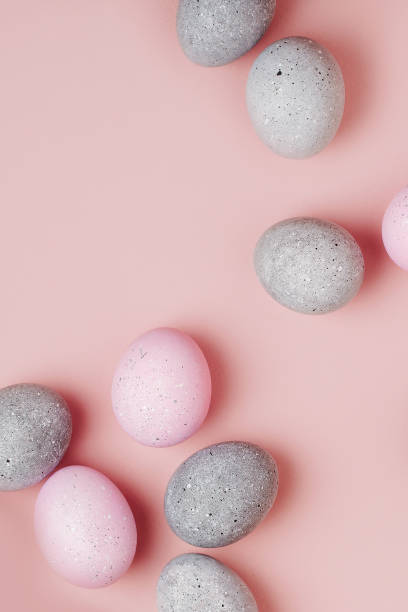 istock Group pale pink and gray Easter eggs on pastel  background. Flat lay 1126639934