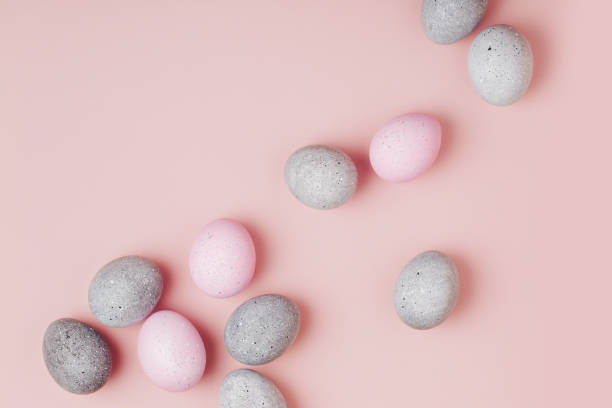 istock Group pale pink and gray Easter eggs on pastel  background. Flat lay 1126640302