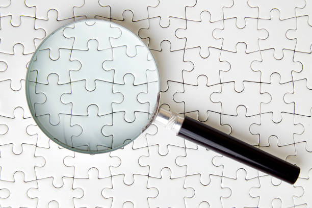 istock Puzzle standing under the magnifying glass 1126640897