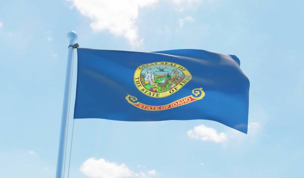 istock Idaho (USA) flag waving against blue sky 1126642129