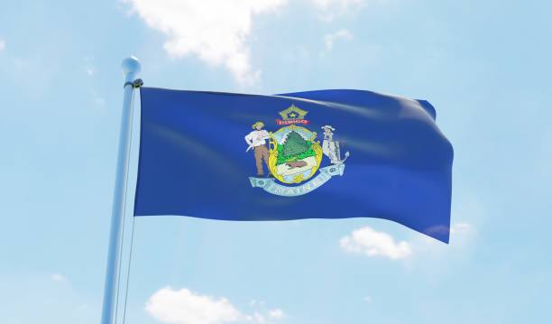 istock Maine (USA) flag waving against blue sky 1126642271