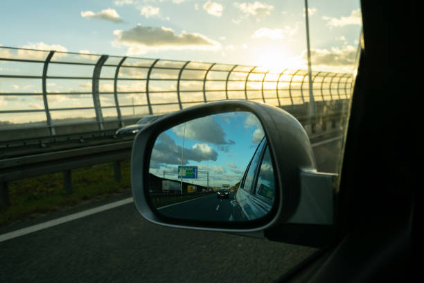 istock rear miror sun over the road 1126643620