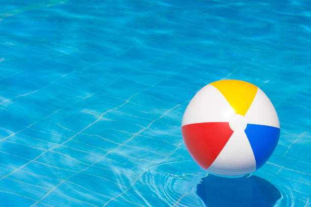 istock Colorful inflatable ball floating in swimming pool, 1126643818