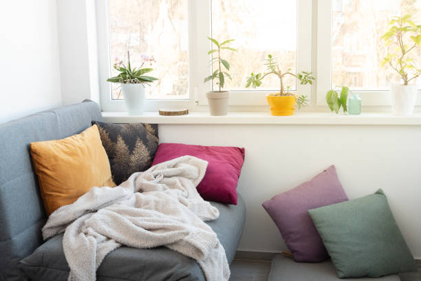 Cozy comfortable room with lot of light from window Cozy comfortable room with lot of light from window with sofa and cushions nook architecture photos stock pictures, royalty-free photos & images