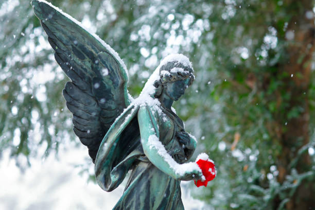 istock Antique Angel Statue with a red Rose 1126644481