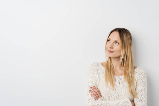istock Thoughtful young woman standing thinking 1126645804