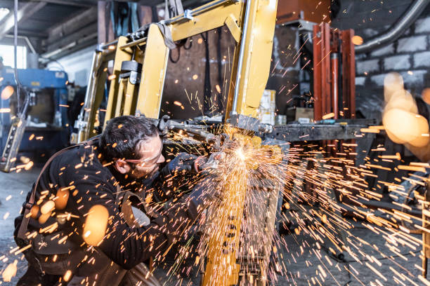 istock Young worker with a sander machine in a factory 1126646569