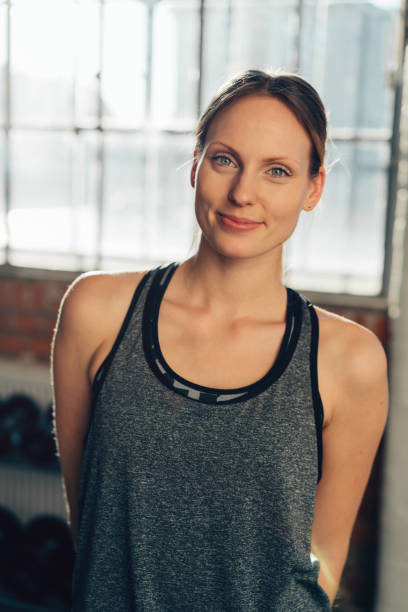 istock Pretty athletic young woman in a gym 1126648595