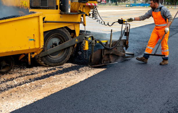 istock Machine operator to spread asphalt, intervenes on the control panel to adjust the asphalt paving 1126648656