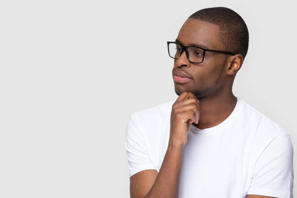 istock Thoughtful african man holding hand on chin looking at copyspace 1126648988