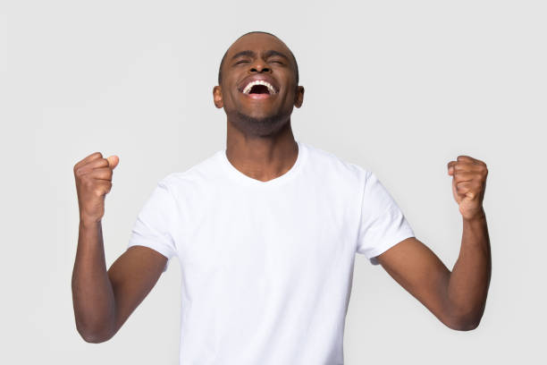 istock Overjoyed happy young african american man triumphant celebrating win 1126648989