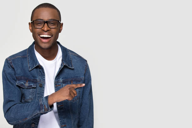 istock Happy excited african man laughing pointing finger at copy space 1126649015
