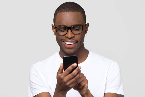 istock Happy young african man using smartphone gadget social media apps 1126649027