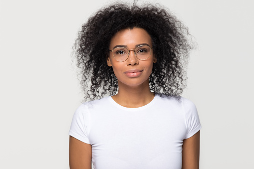 Smart attractive young african woman wearing glasses looking at camera