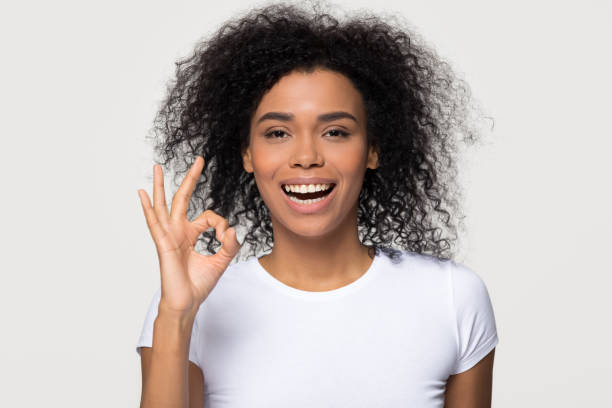 istock Happy black woman showing ok gesture smiling looking at camera 1126649067