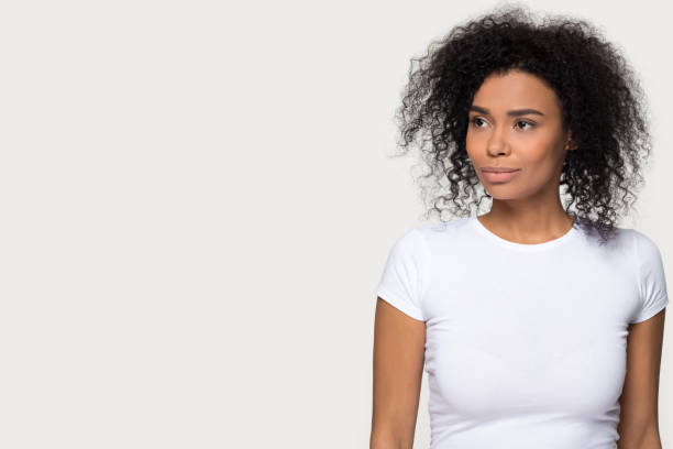 istock Confident thoughtful black woman looking away dreaming isolated on background 1126649094