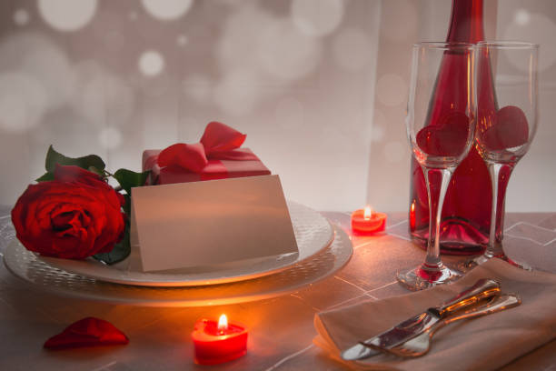 istock Valentines day table place setting with red roses and champagne. Invitation for a date. 1126653102