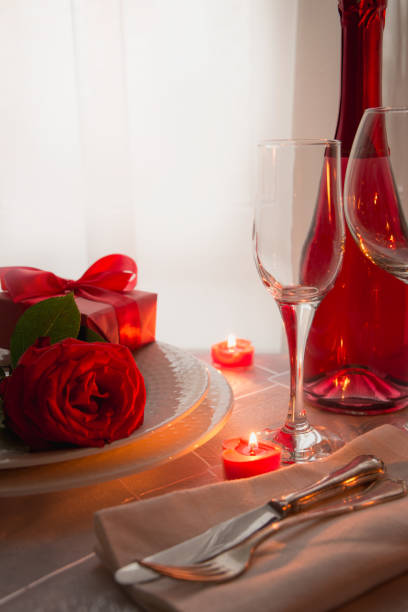 istock Valentines day table place setting with red roses and champagne. Invitation for a date. 1126653103