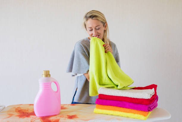 Caucasian ethnicity female feeling happy about soft fresh laundry