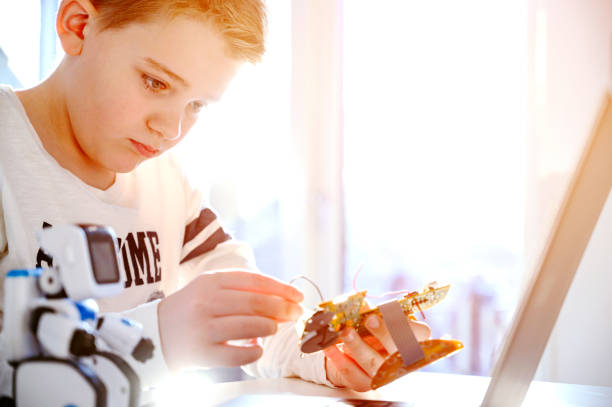 istock Child concentrates on a science project and tries to get a circuit board to work 1126657596