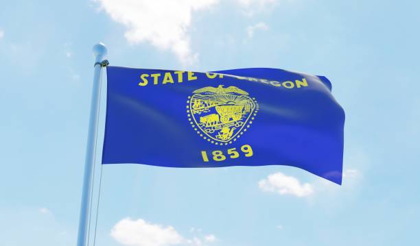 istock Oregon (USA) flag waving against blue sky 1126657922