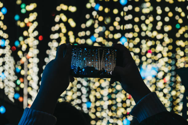 istock Hands holding unidentified mobile phone above head, taking photos. 1126659013