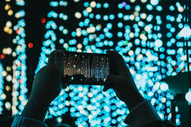 istock Hands holding mobile phone above head, taking photos. 1126659015