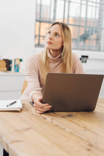 istock Creative woman thinking of a new idea during work 1126662755